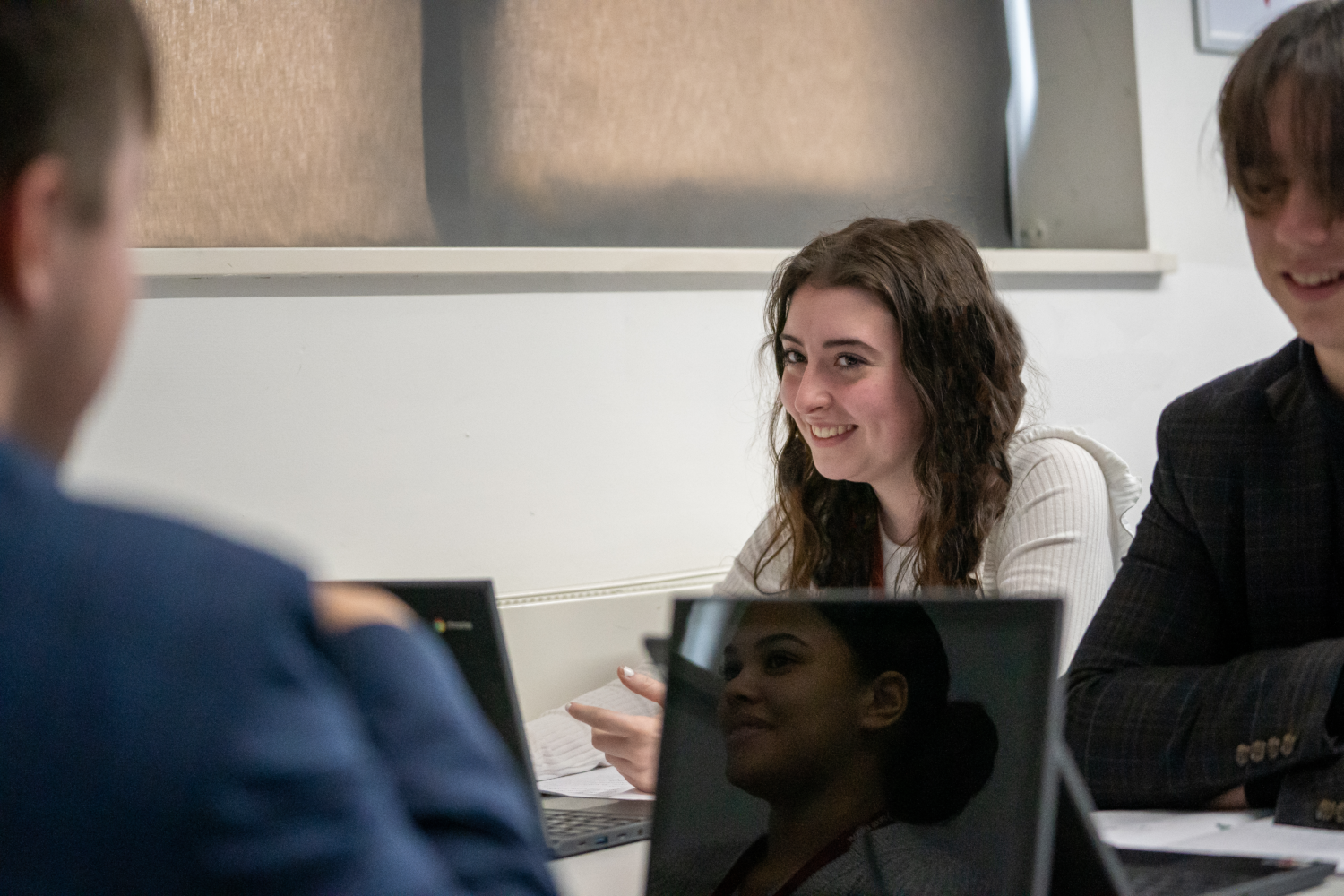 Four students sat round a table during class using Chromebooks