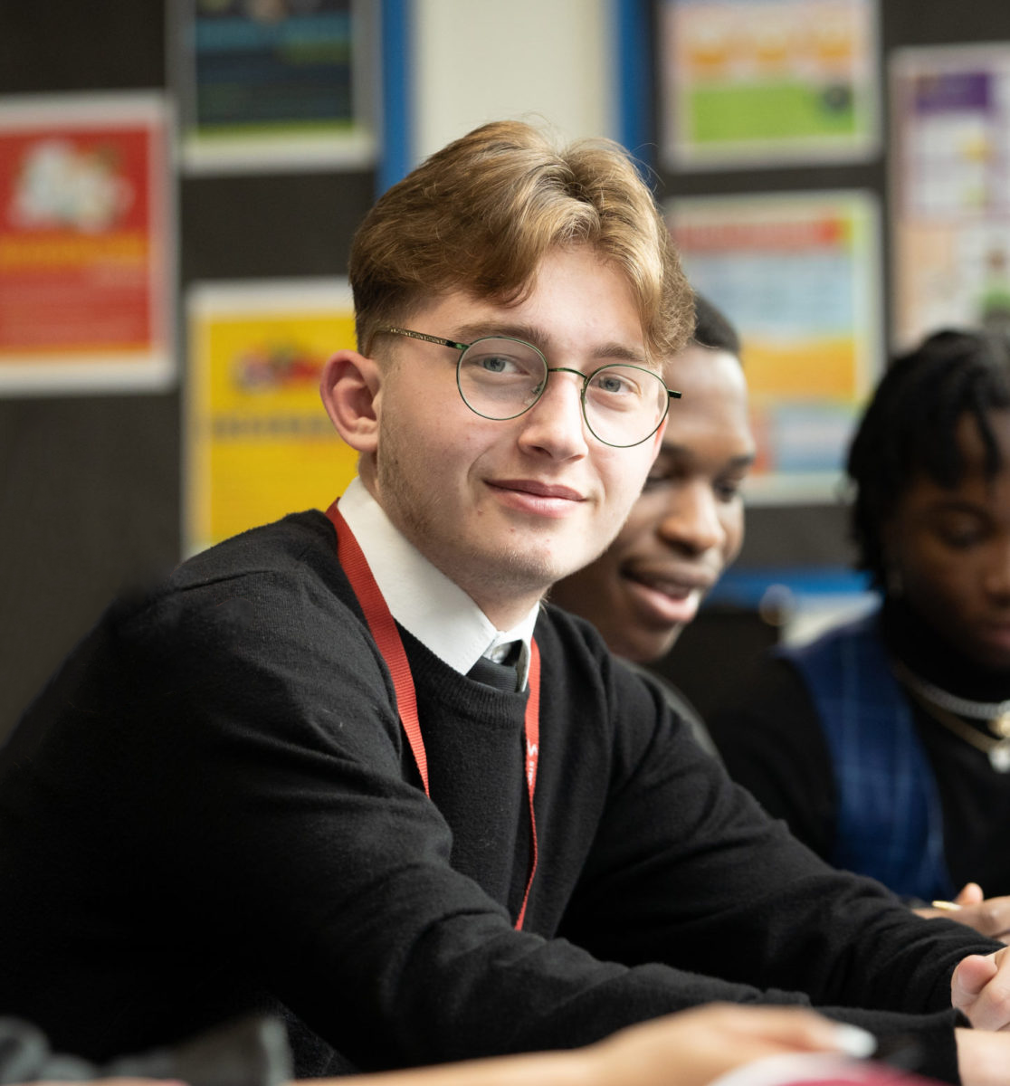 Close up of a sixth form student smiling at the camera