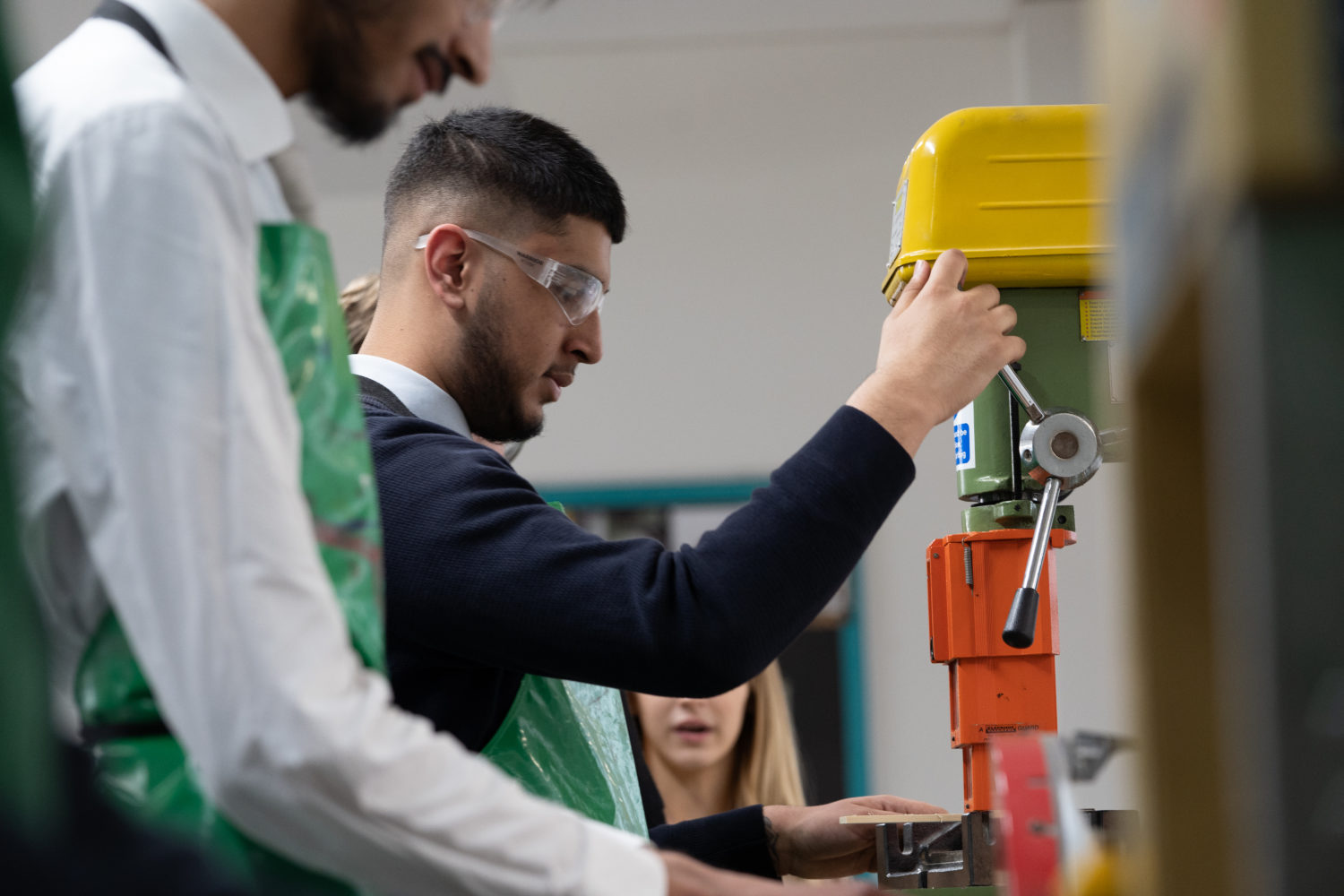 Post-16 student using a cutting machine during a lesson