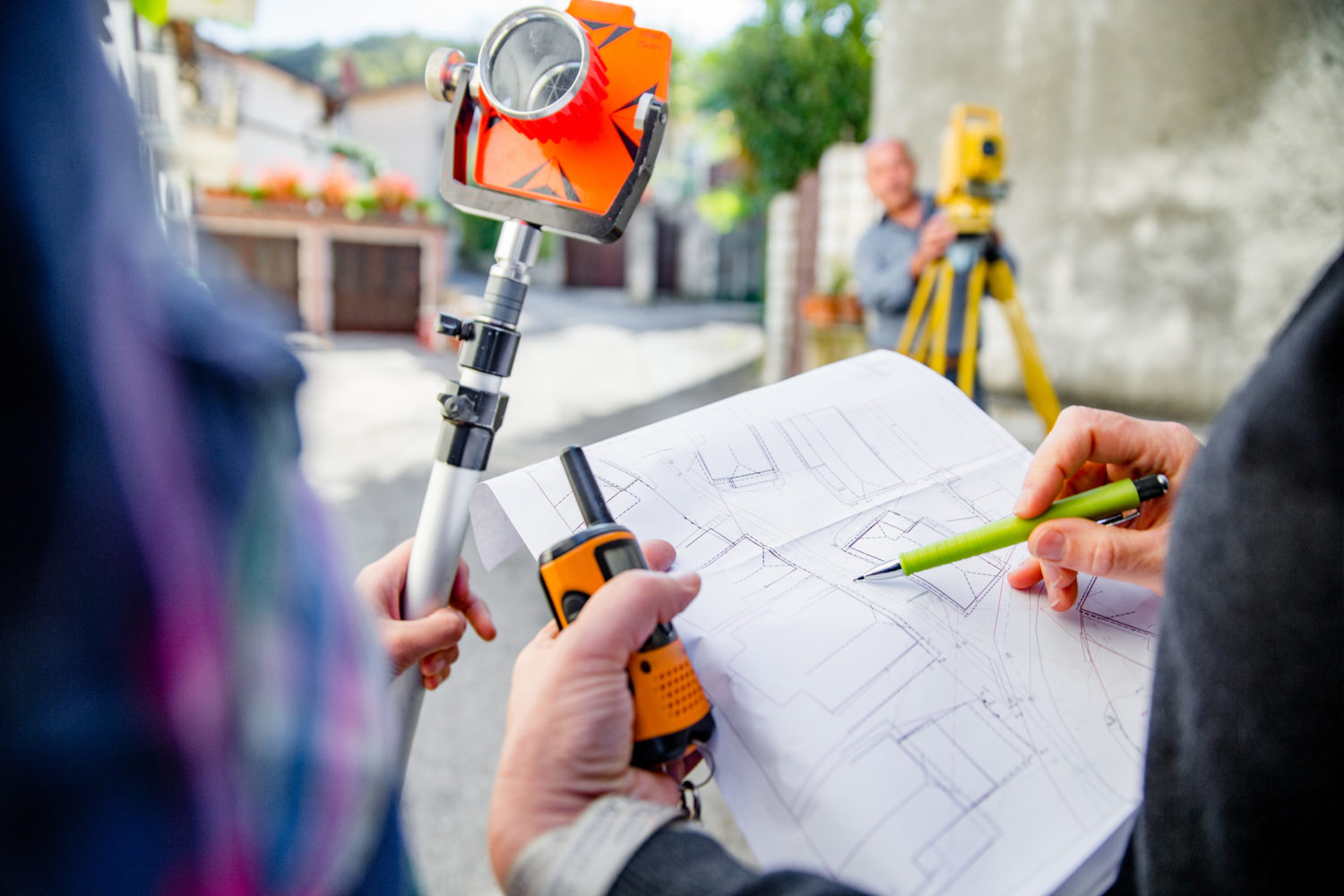 Female Surveyors Looking at Map on City Street.