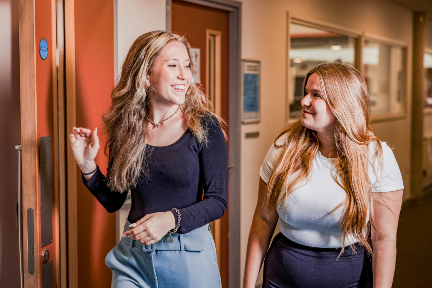 Two Sixth Form students walking through a corridor