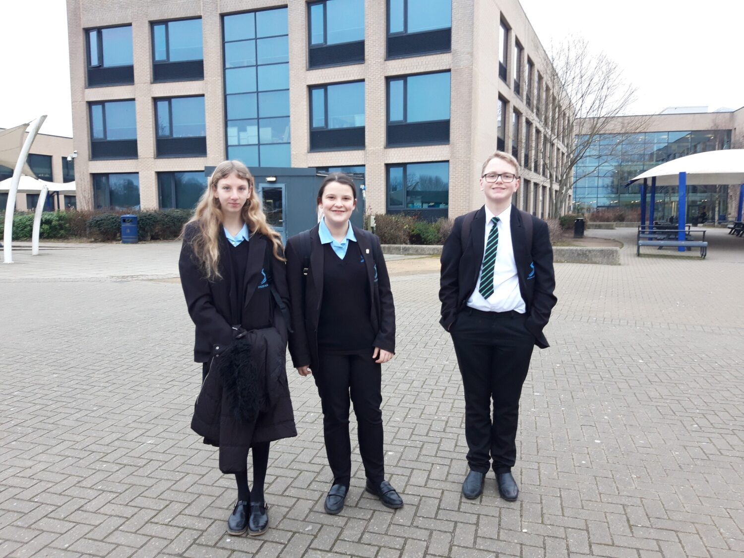 3 students in school uniform smiling