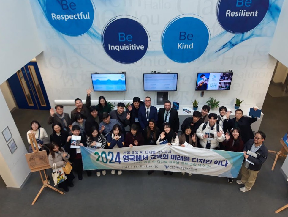 A group of people smiling for a photo and holding up a banner